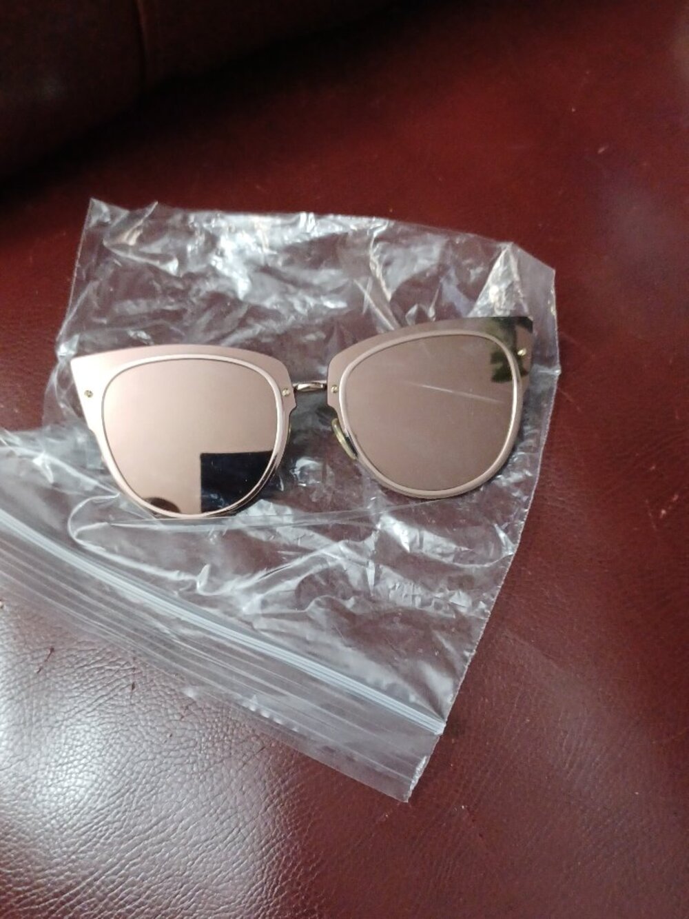 A Brand New pair of Rose Colored Sun Glasses